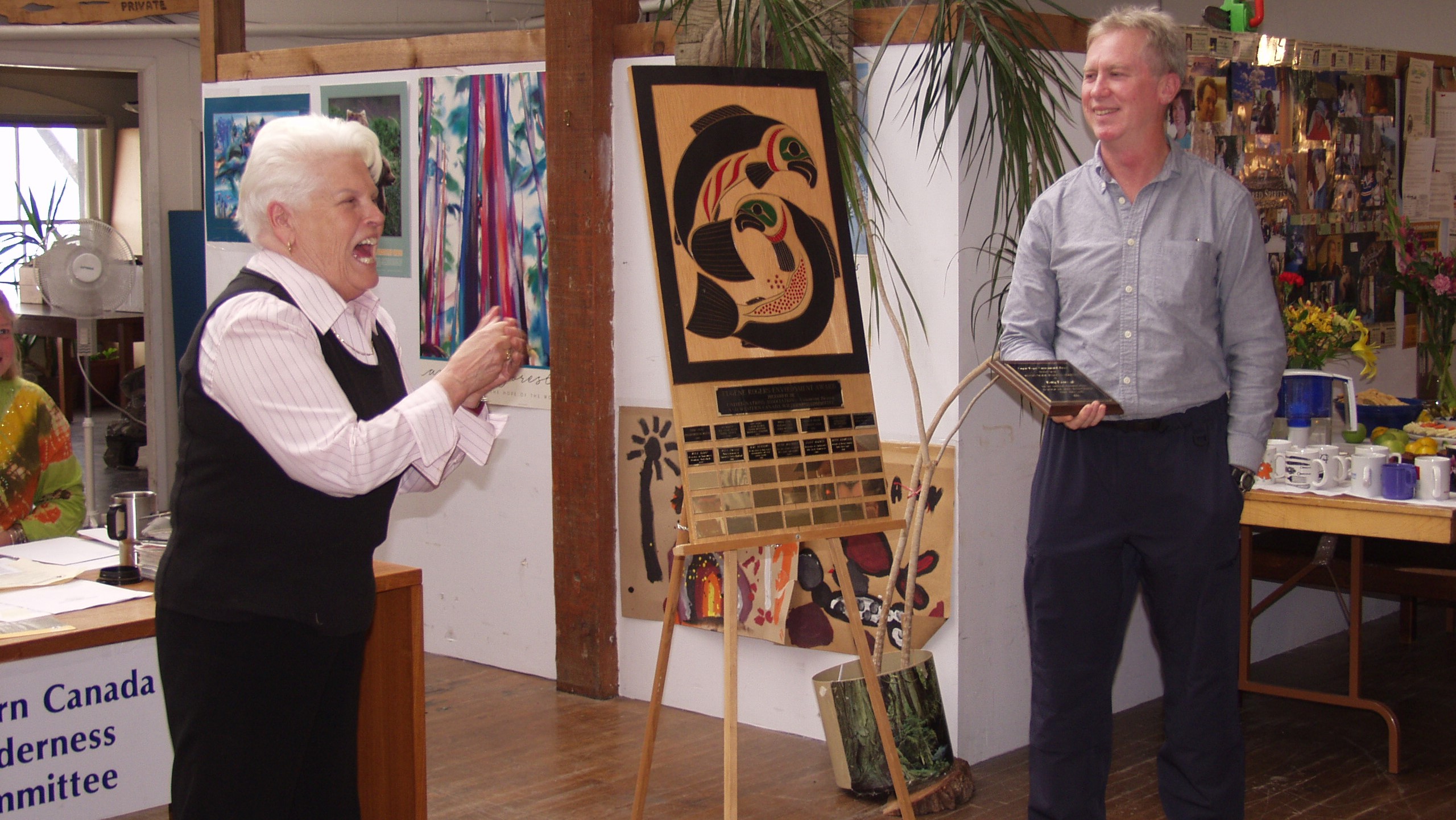 Betty Krawczyk (left) receiving the Eugene Rogers Award plaque from Joe Foy (right).