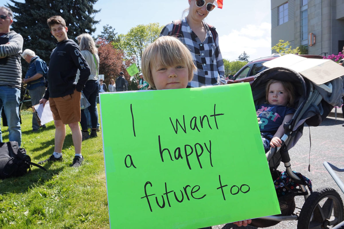 Four-year-old Jonah Arbez holds a protest sign at Friday’s Strike for Climate on the steps of Nanaimo City Hall. (COLE SCHISLER/Black Press)