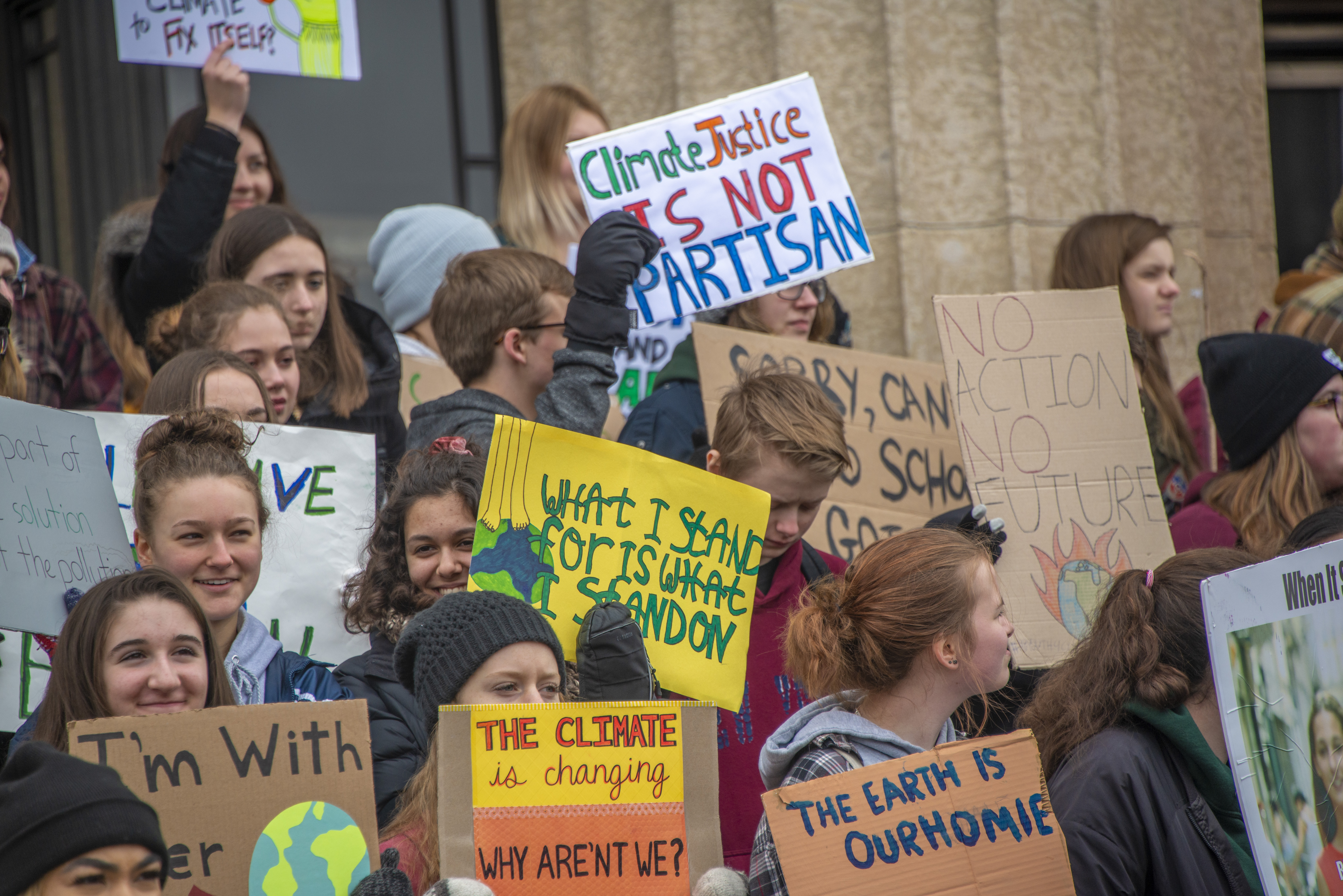 Students with signs asking for climate action.