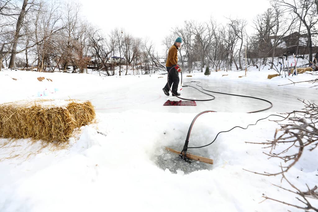 RUTH BONNEVILLE / WINNIPEG FREE PRESS  Reder draws water from the Seine River to flood the homemade rink