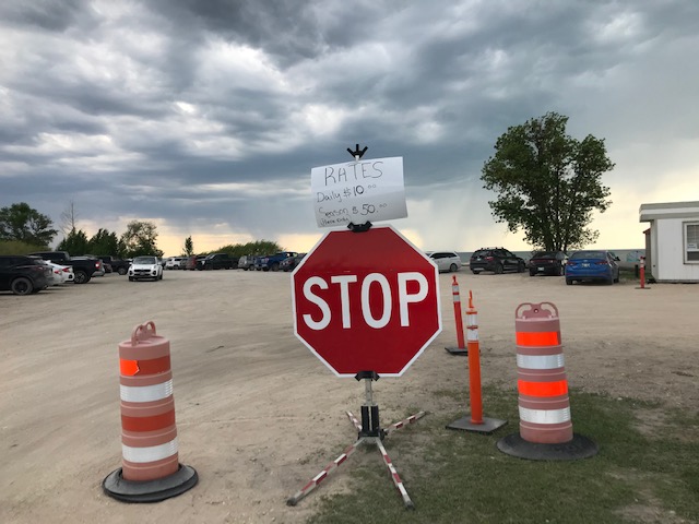 A stop sign in the park's parking lot with a "Rates" sign attached