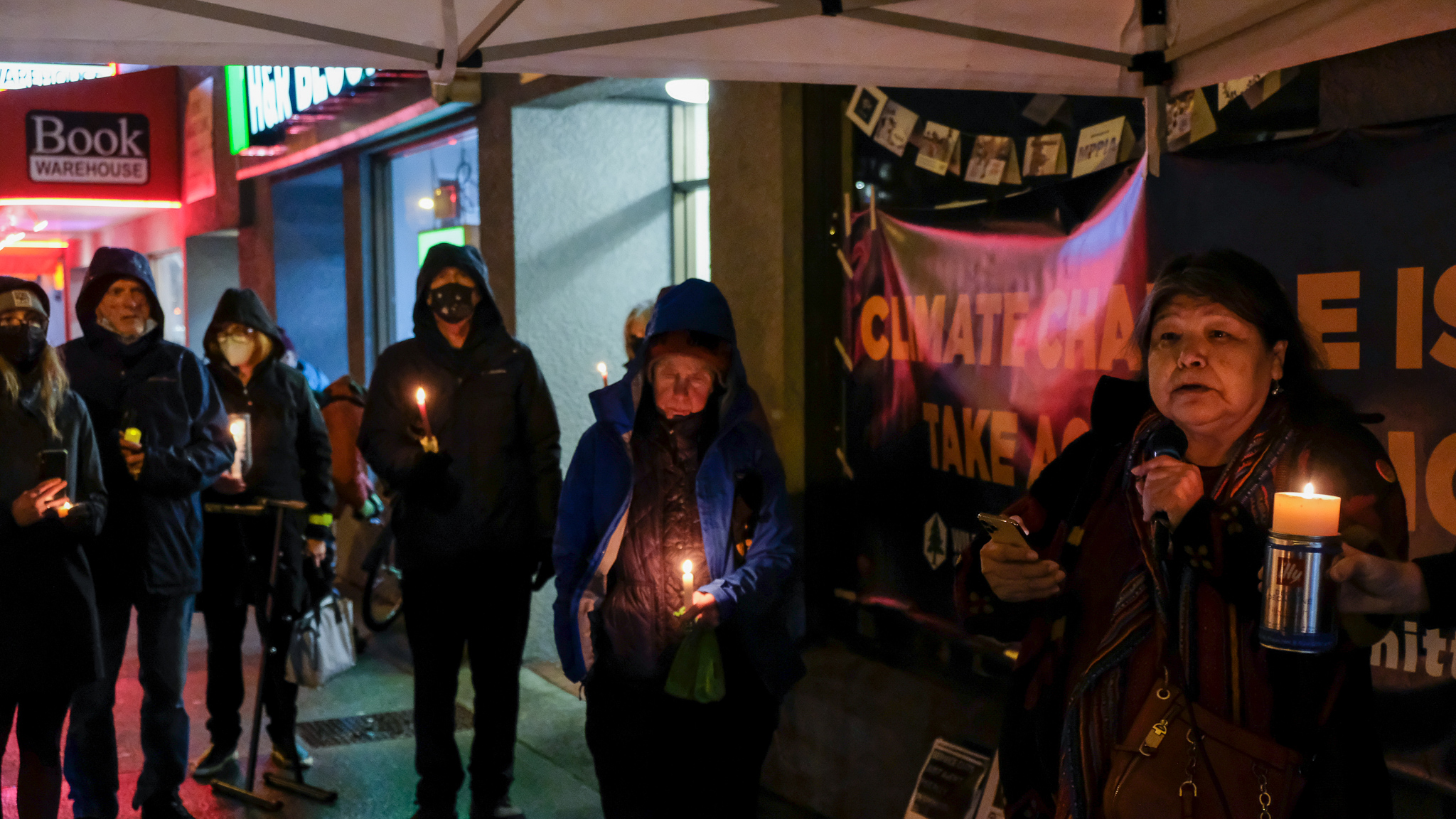 People standing with candles.