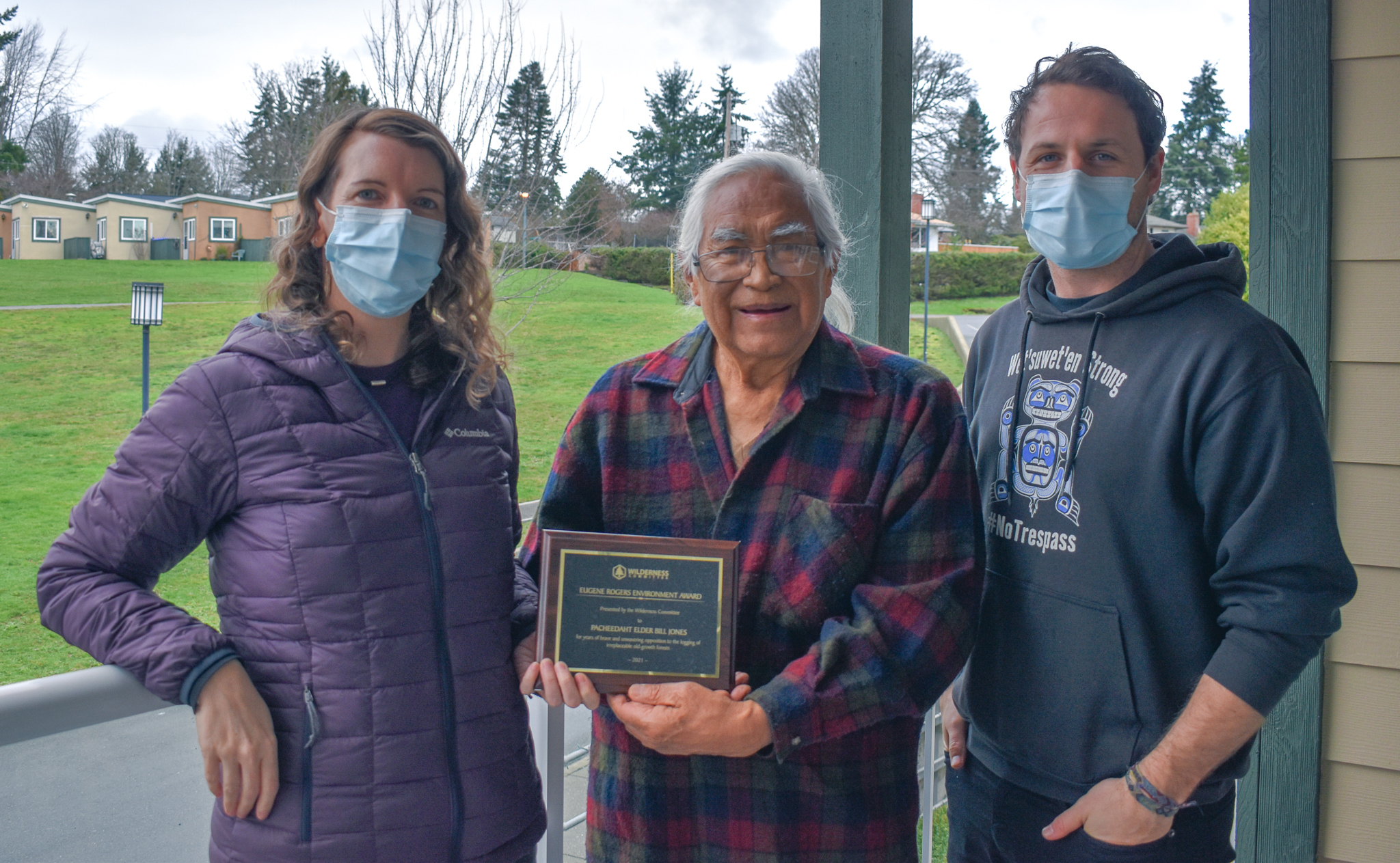 Pacheedaht First Nation Elder Bill Jones receives the 2021 Eugene Rogers Environmental Award from Wilderness Committee Vancouver Island Campaign Organizer Emily Hoffpauir and National Campaign Director Torrance Coste. Photo: Wilderness Committee