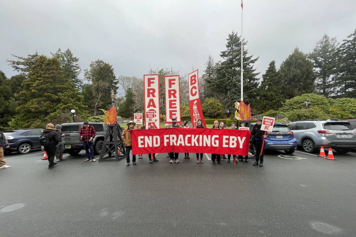 A group of people holding a banner that says "End Fracking Eby". End of image description.