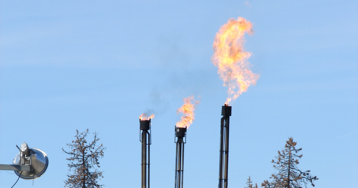 Fracking operations near some trees. End of image description. 