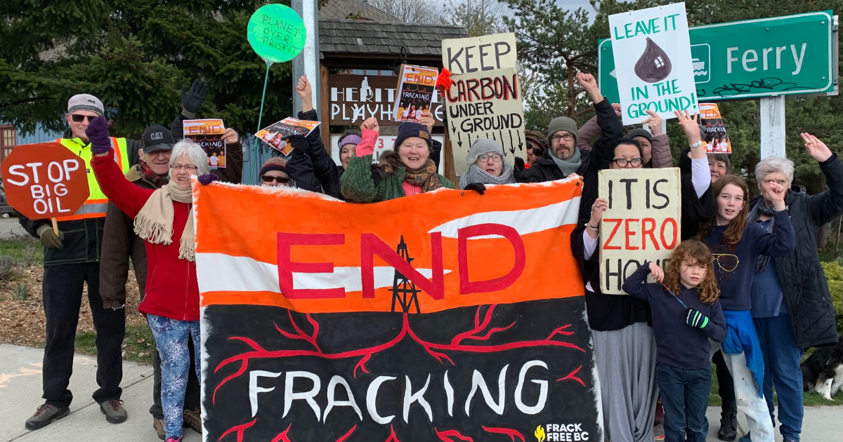 A group of people holding up a "END FRACKING" banner. End of image description.