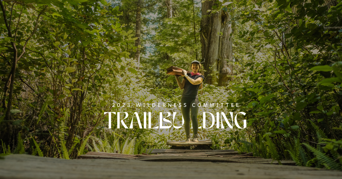 A person carrying logs through the forest. Text over the image says "2023 Wilderness Committee Trailbuilding." End of image description.