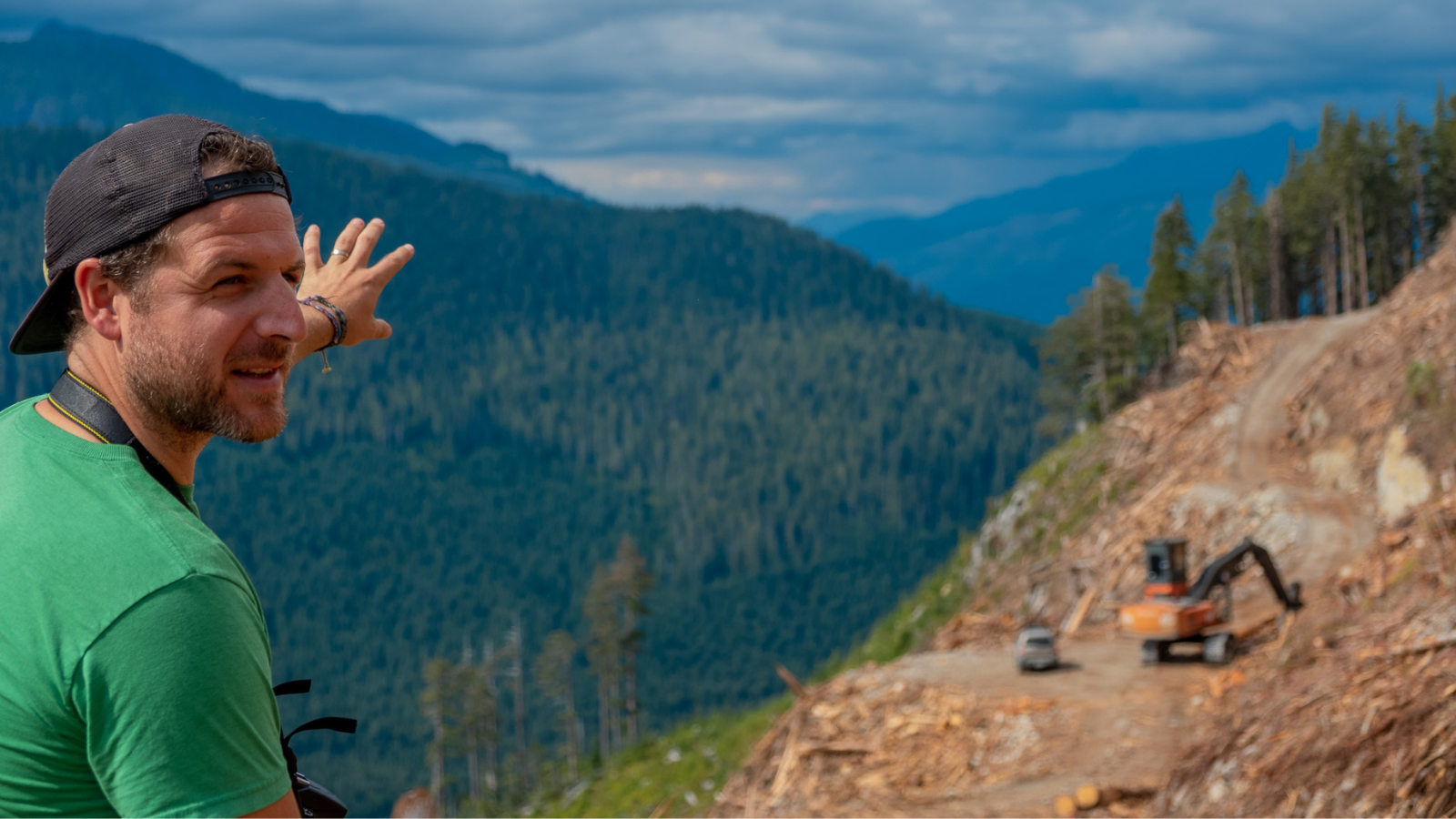 Torrance Coste in front of a clearcut