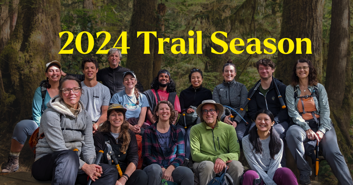 A group of people posing in a forest. Text on the image says "2024 Trail Season". End of image description.