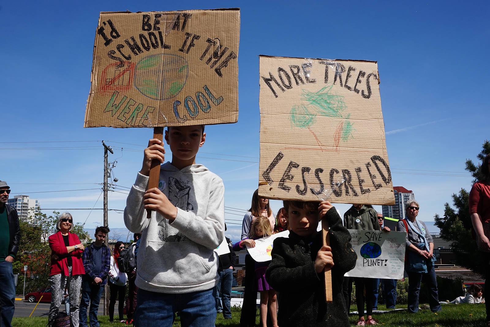 Kolby and Carter Myden lift home-made signs.