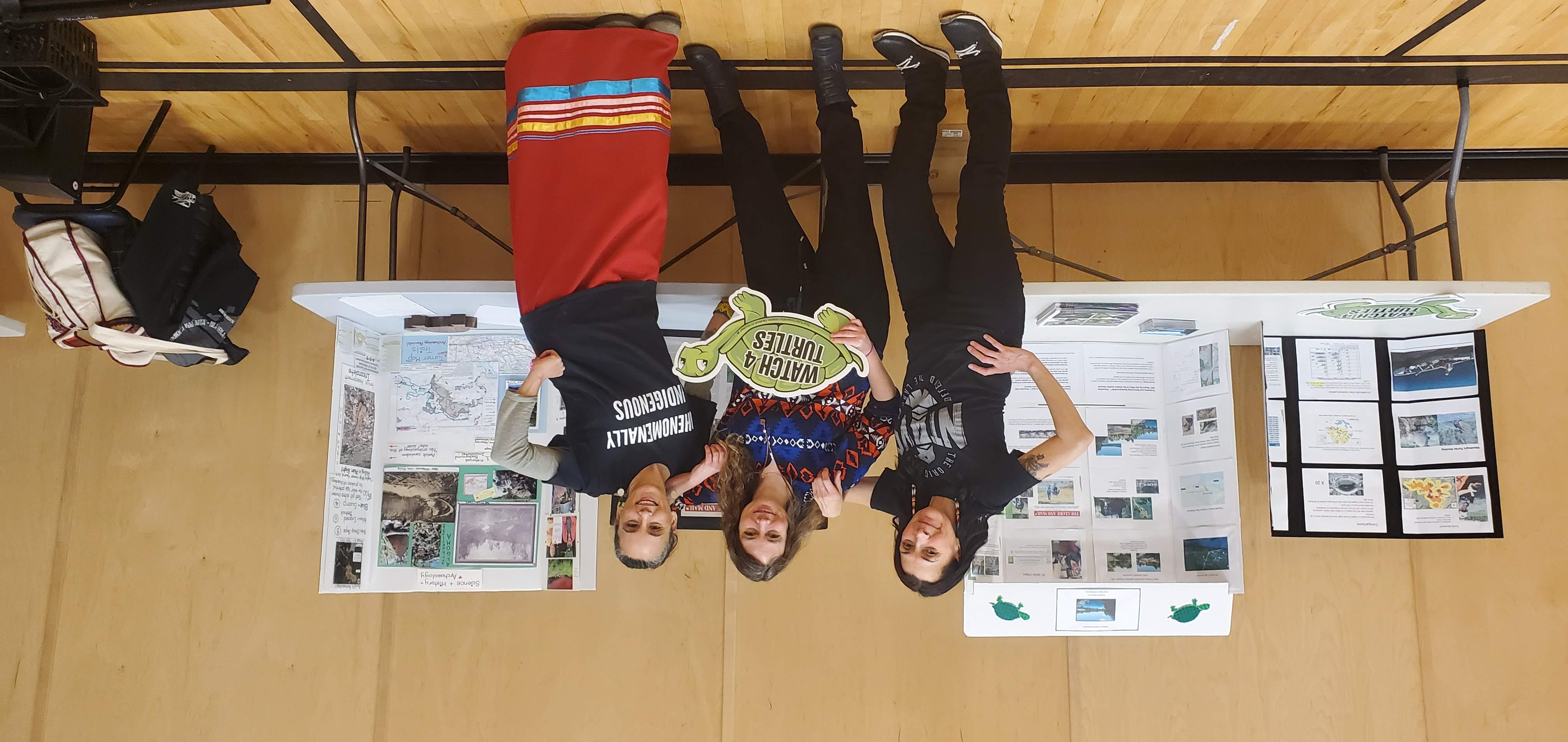 Campaigner Katie Krelove with Serpent River First Nation members at an educational table about threats to the Blanding's Turtles