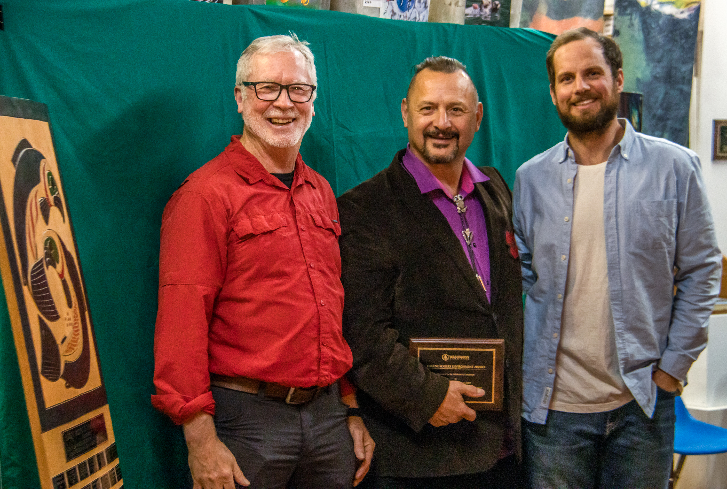 Chief James Hobart standing with the Eugene Rogers Award with Joe Foy (left) and Kegan Pepper-Smith (right).