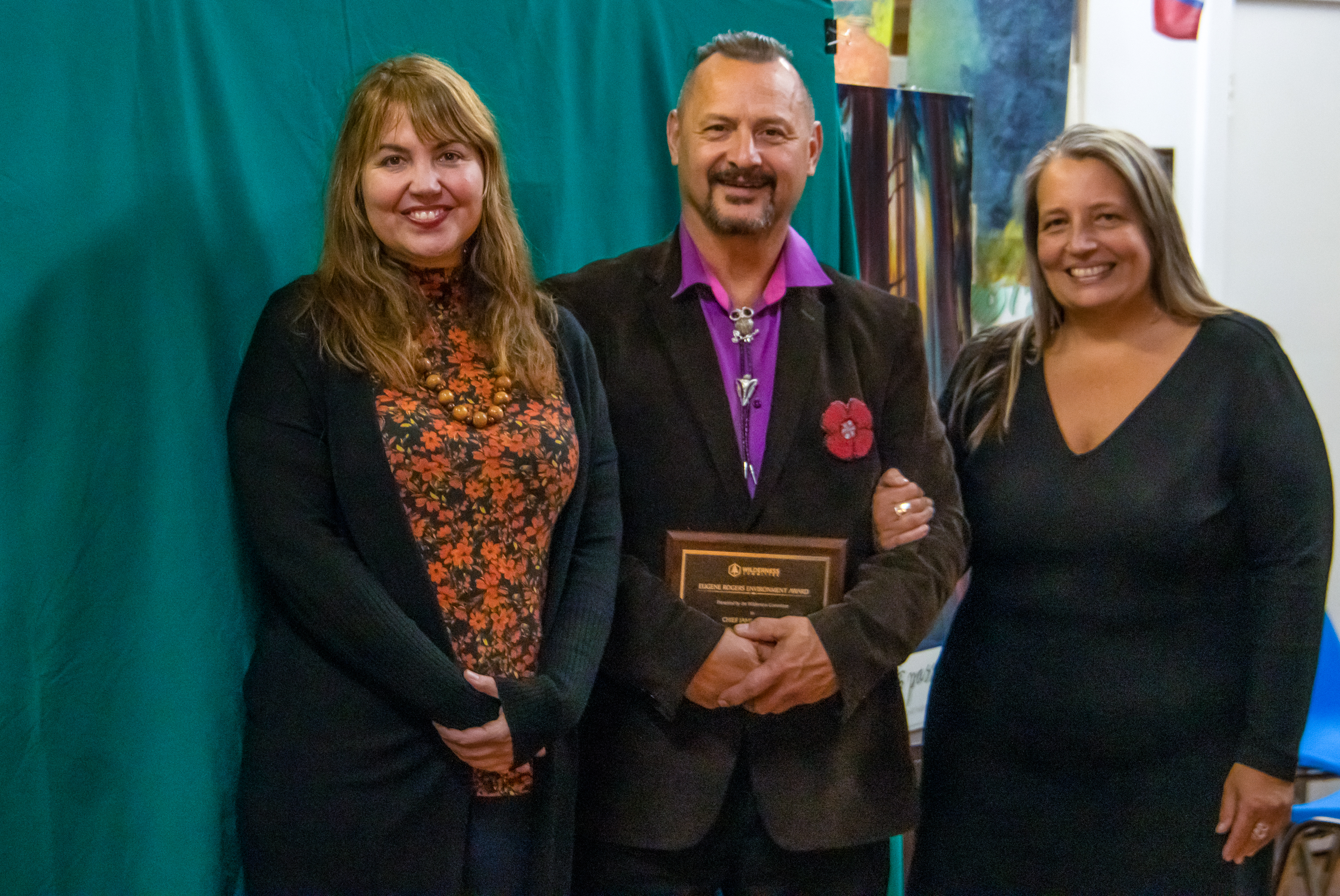 Chief James Hobart standing with the Eugene Rogers Award with Joe Foy (left) and Kegan Pepper-Smith (right).