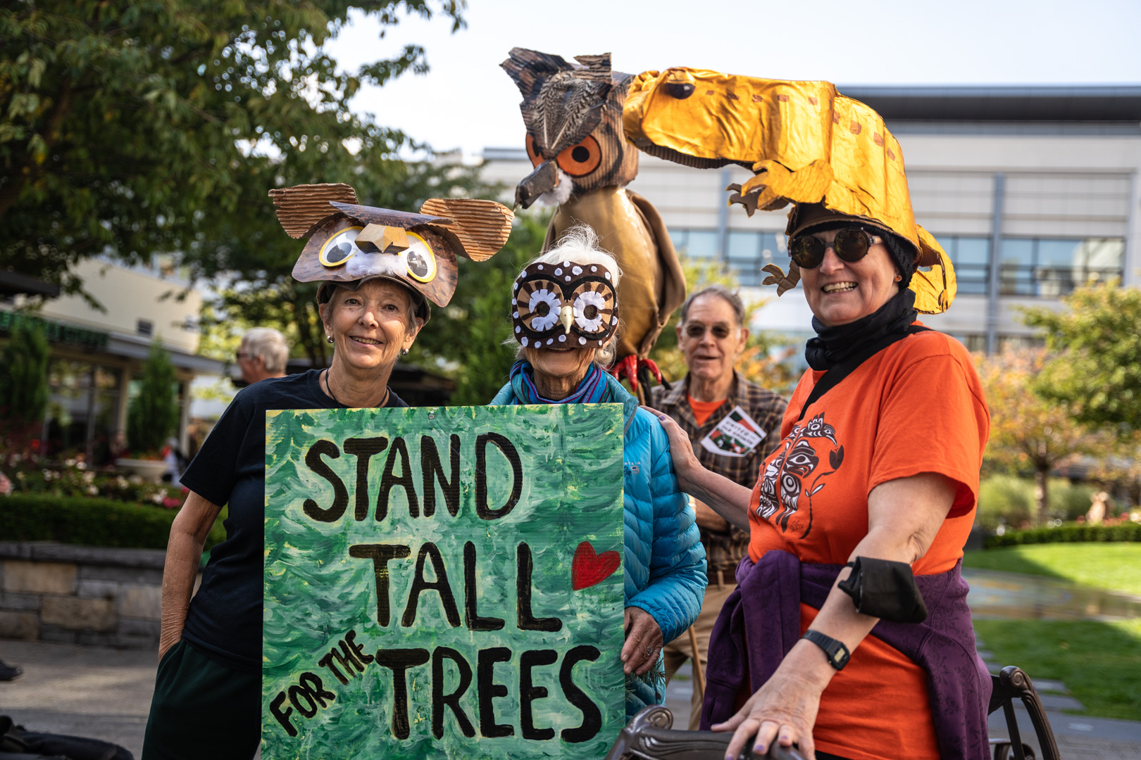 A group of people dressed up as various at-risk animals that rely on old-growth. End of image description.