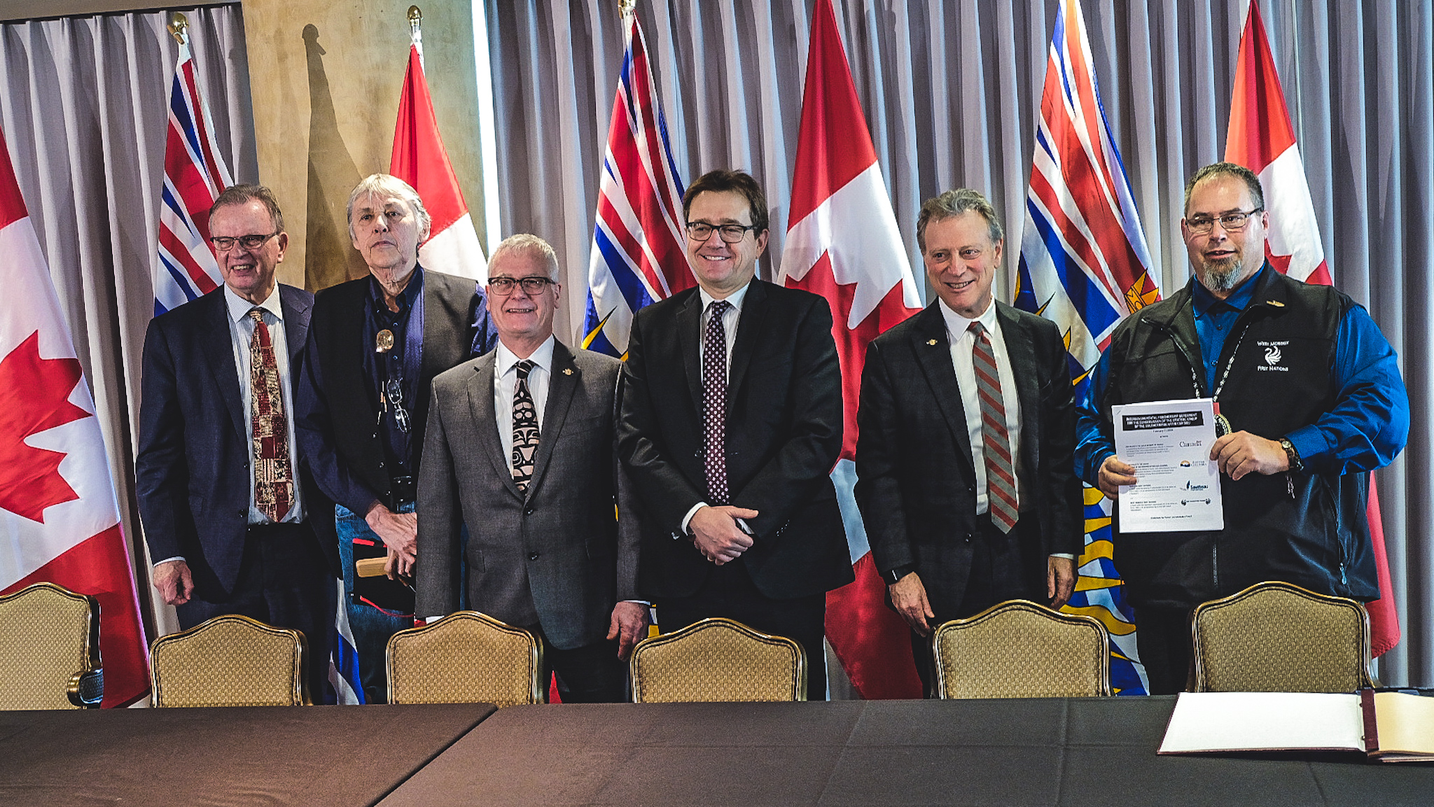 Federal and provincial ministers standing with Chief Owen Wilson and Chief Ken Cameron