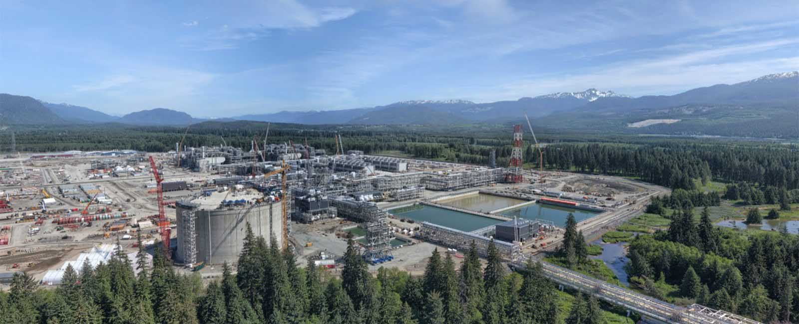 An aerial shot of a tanker in a forested/ mountainous area. End of image description.