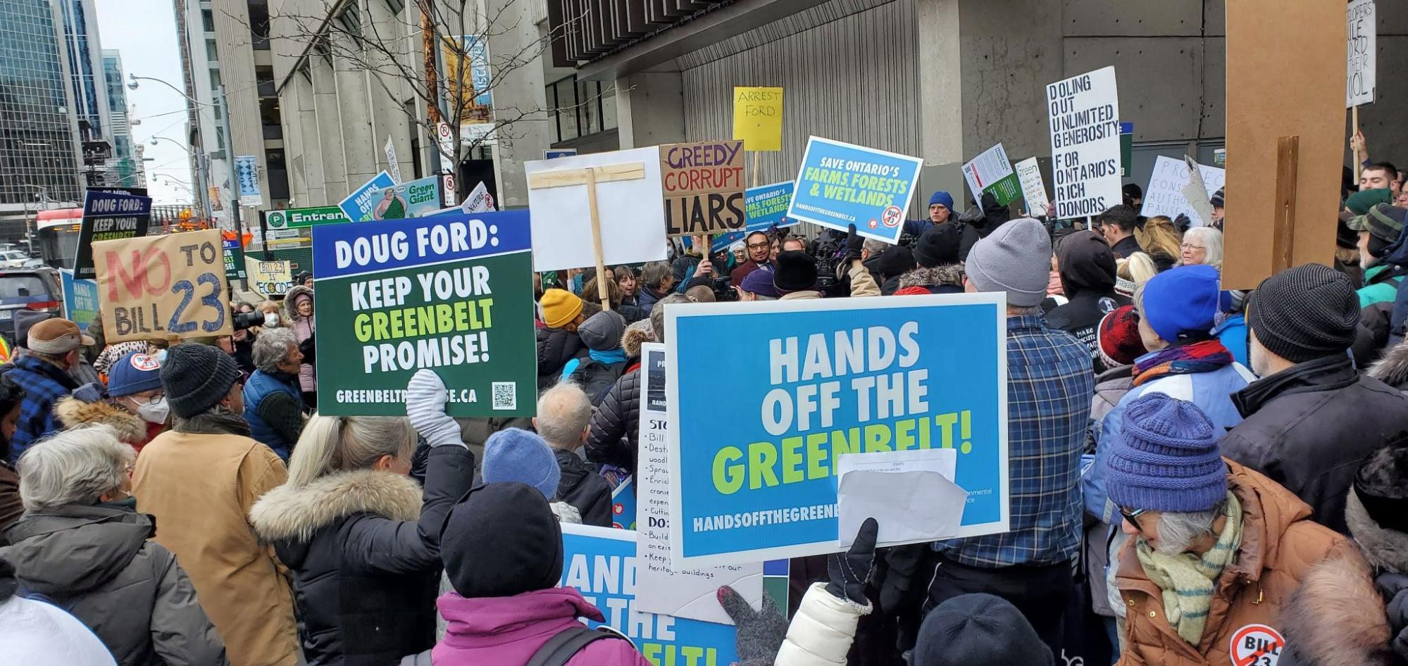 A rally with various signs supporting the Greenbelt. 