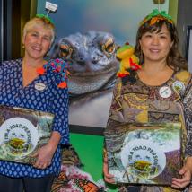 People holding donation boxes in western toad themed outfits