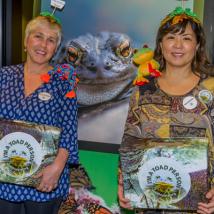 Two volunteers dressed up in toad attire and holding donation boxes.