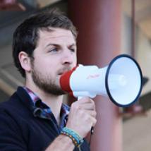 Campaigner Torrance Coste holding a megaphone