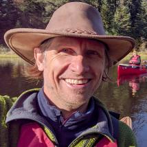 Headshot of Eric Reder canoeing with his son North