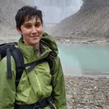 Tobyn posing in front of a hot springs. End of image description. 