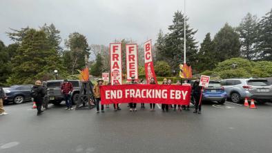 A group of people holding a banner that says "End Fracking Eby". End of image description. 