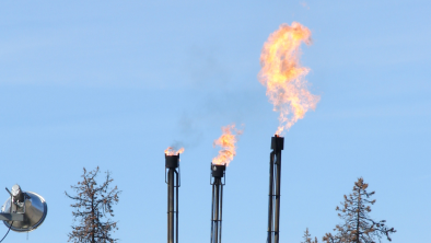 Fracking operations near some trees. End of image description. 