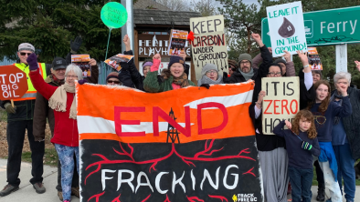 A group of people holding up a "END FRACKING" banner. End of image description.