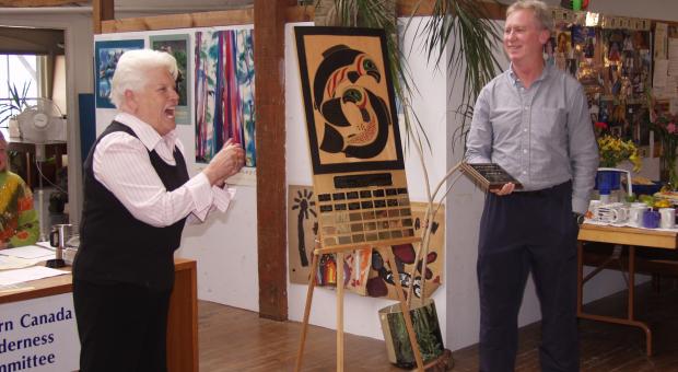 Betty Krawczyk (left) receiving the Eugene Rogers Award plaque from Joe Foy (right).