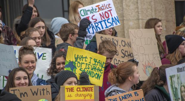 Students with signs asking for climate action.