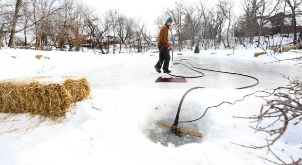 RUTH BONNEVILLE / WINNIPEG FREE PRESS  Reder draws water from the Seine River to flood the homemade rink