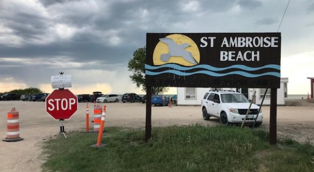 The sign and parking lot at St. Ambroise Beach