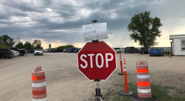 A stop sign in the park's parking lot with a "Rates" sign attached