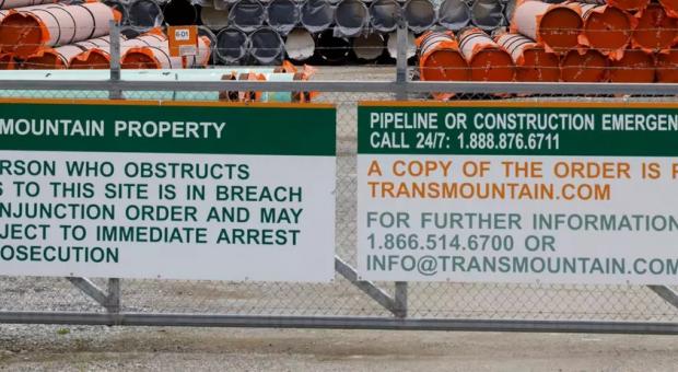 Pieces of the Trans Mountain oil pipeline project sit in a storage lot outside of Hope, British Columbia, Canada, on June 6, 2021. (Photo by Cole Burston/AFP via Getty Images)