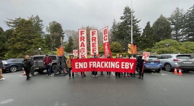 A group of people holding a banner that says "End Fracking Eby". End of image description. 