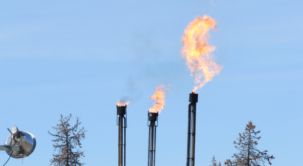 Fracking operations near some trees. End of image description. 