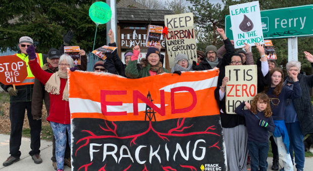 A group of people holding up a "END FRACKING" banner. End of image description.