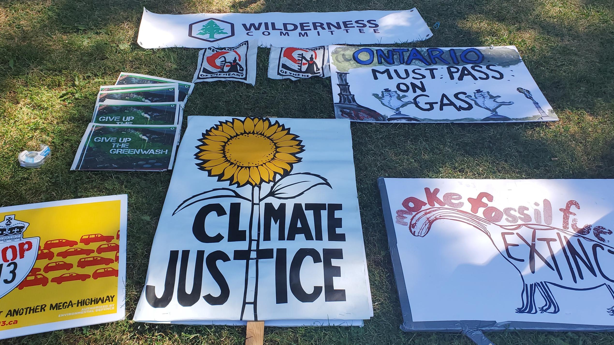 Signs on display at a climate protest in 2023