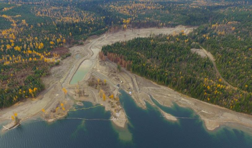 An aerial shot of Quensel Lake, where surrounded by forests. End of image description.